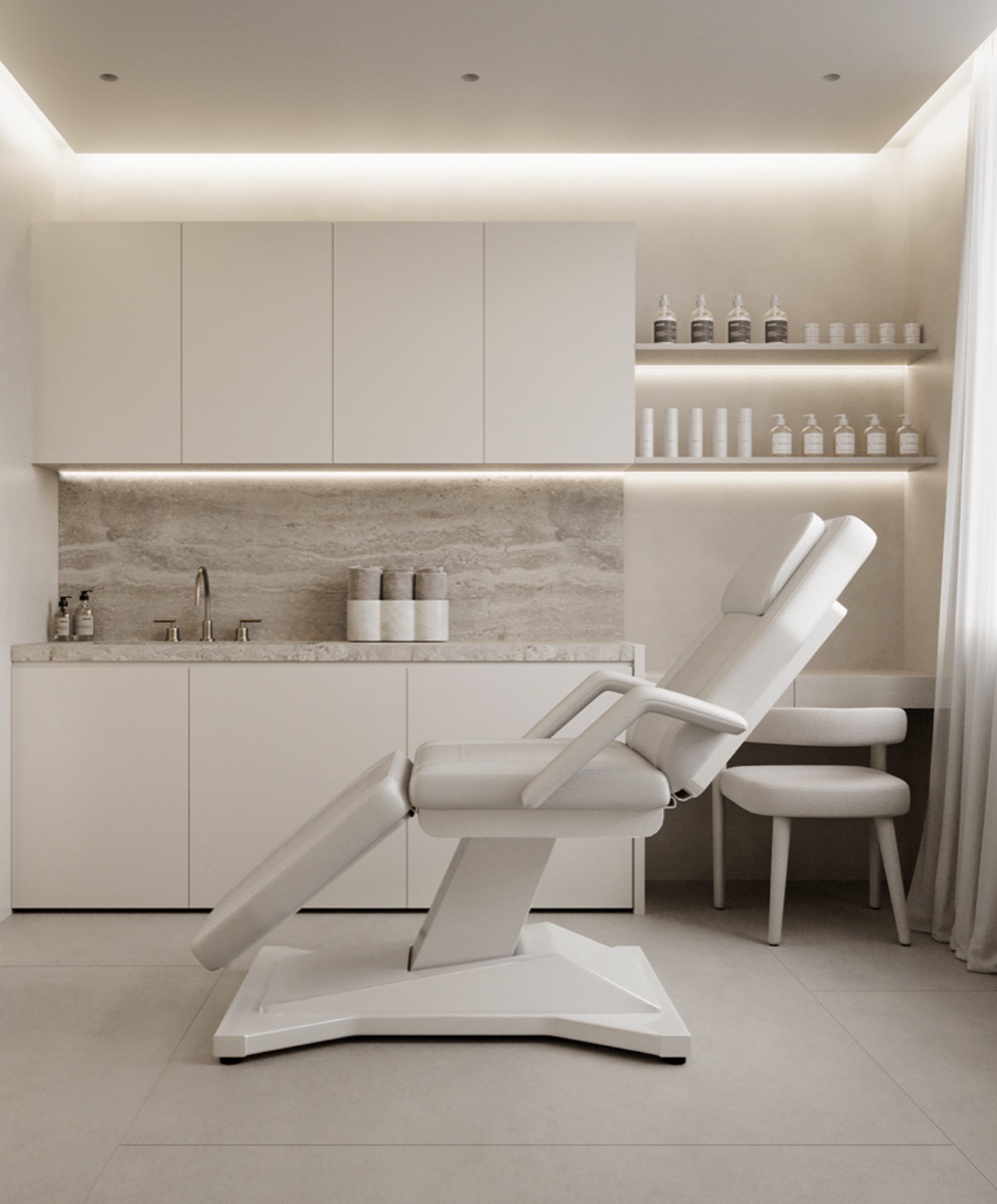 The Face and Co Belfast clinic treatment room, warm neutral interior with travertine and ambient lighting